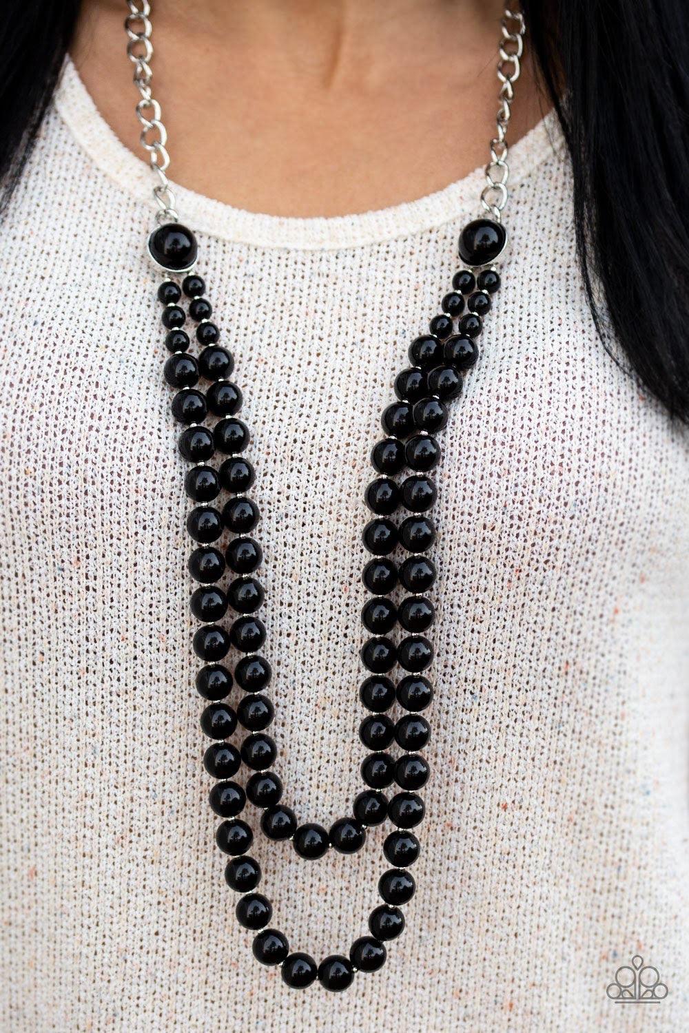 Paparazzi Accessories Endless Elegance - Black A dramatic silver chain gives way to two strands of polished black beads. Infused with matching beaded fittings and dainty silver accents, the beaded strand draped down the chest in a refined fashion. Feature