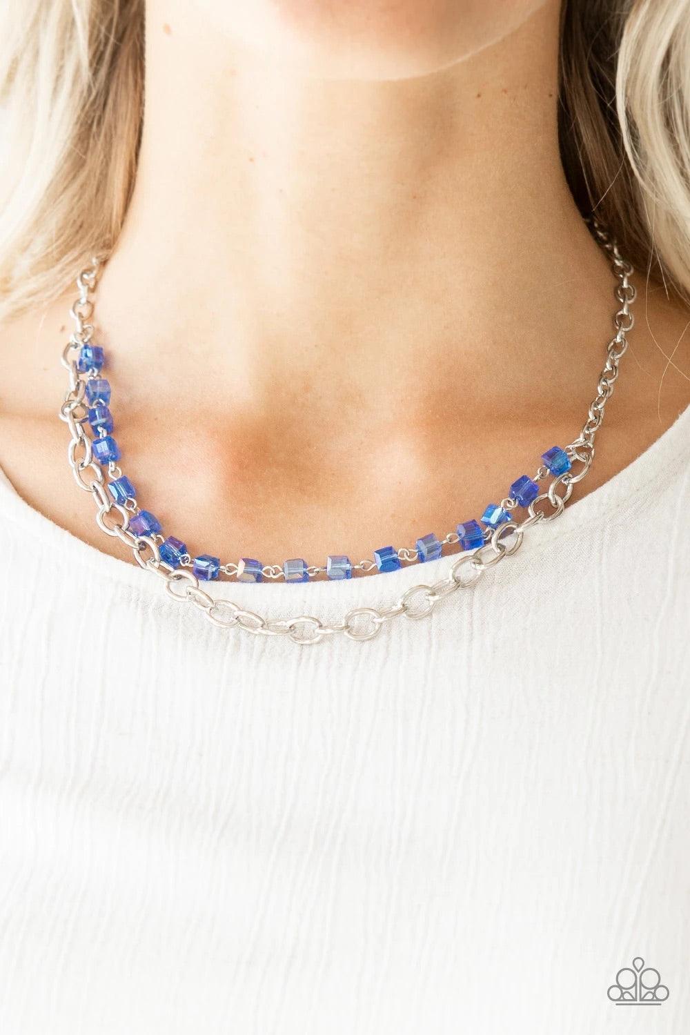 Paparazzi Accessories Block Party Princess - Blue A strand of iridescent blue crystal-like cube beading joins a classic strand of silver chain below the collar, creating refined layers. Features an adjustable clasp closure. Sold as one individual necklace