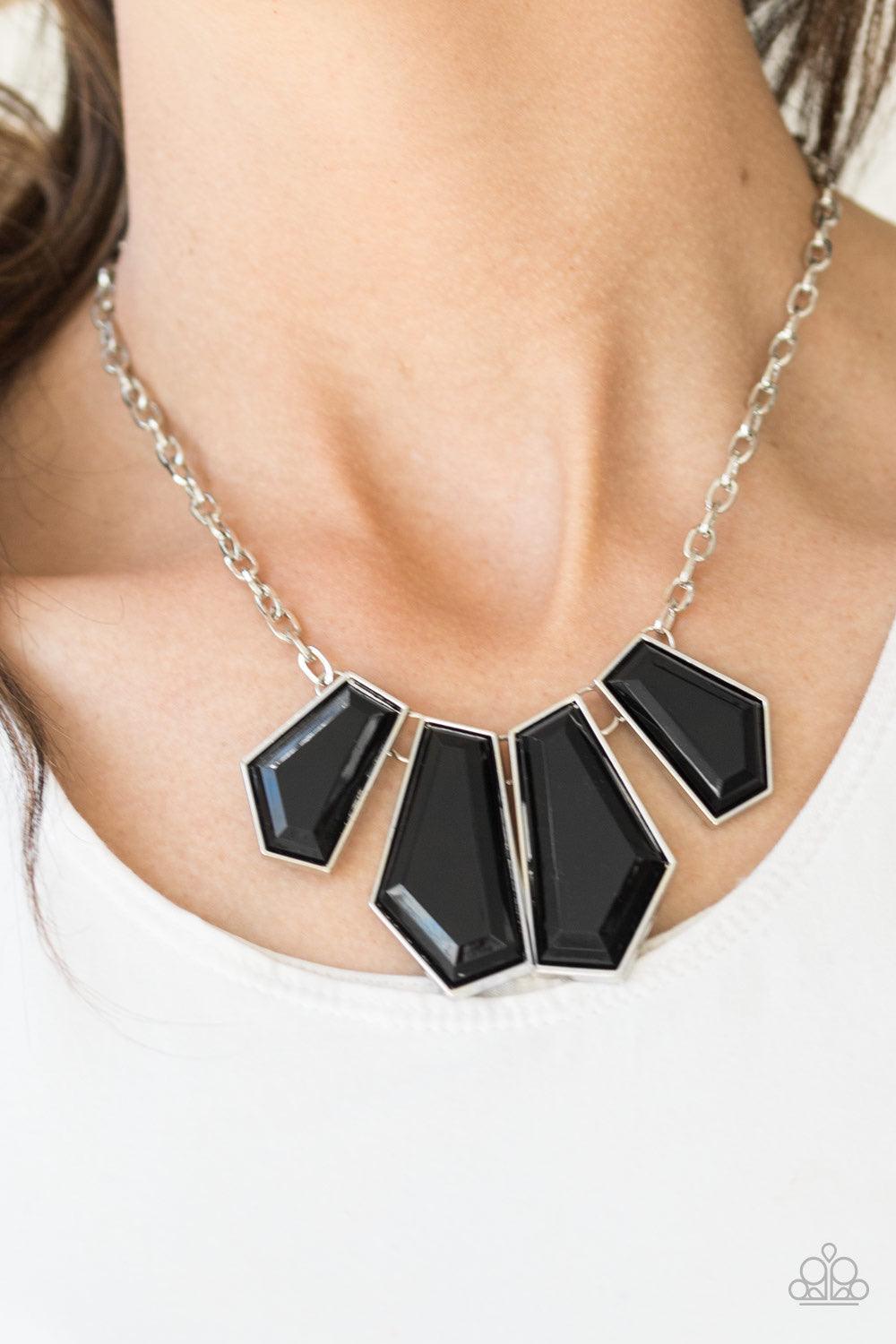 Paparazzi Accessories Get Up and Geo - Black Featuring emerald-style cuts, faceted black beads are pressed into sleek silver frames. The colorful frames join at the bottom of a shimmery silver chain, creating a bold geometric fringe below the collar. Feat