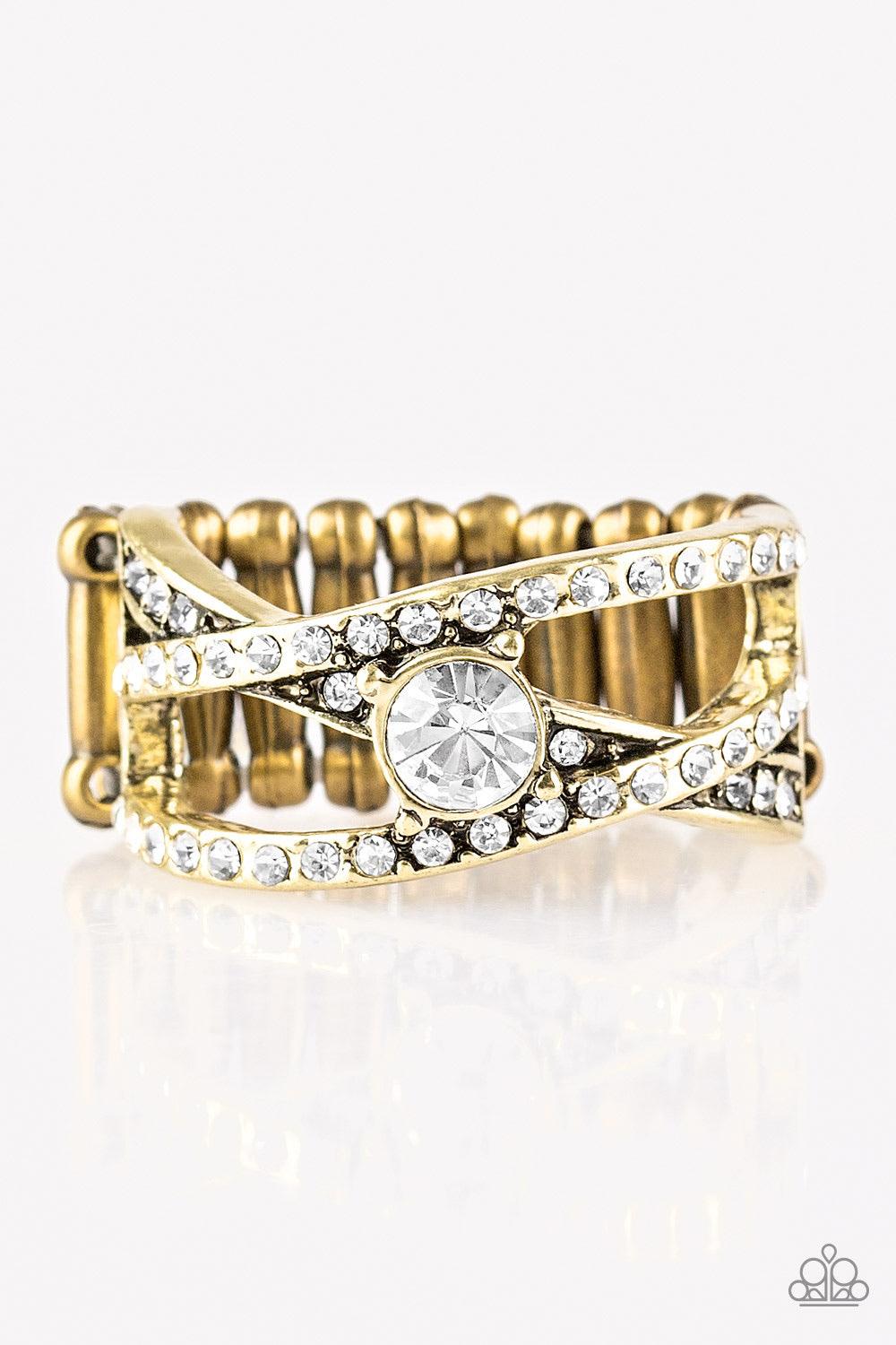 Paparazzi Accessories Prepare To Be Dazzled! * Brass Encrusted in glittery white rhinestones, shiny brass bars crisscross across the finger. A sparkling white rhinestone adorns the center of the bands, creating a dazzling centerpiece. Features a stretchy