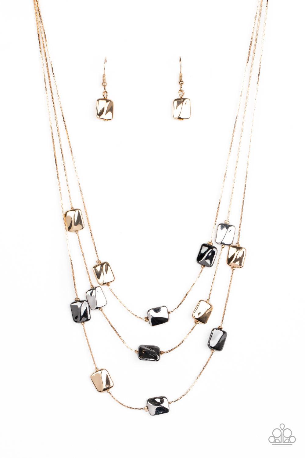 Paparazzi Accessories Downtown Reflections - Gold Featuring a decorative surface, dainty gold, gunmetal, and silver rectangular accents are fitted in place along three sleek gold chains, creating refined layers below the collar. Features an adjustable cla