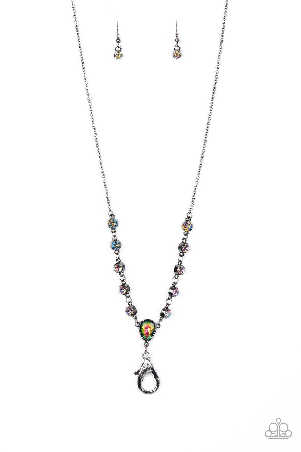 Paparazzi Accessories Unfathomable Fierceness - Multi A sparkly series of glassy oil spill rhinestones gives way to an oversized oil spill rhinestone teardrop pendant at the bottom of a dainty gunmetal chain. A lobster clasp hangs from the bottom of the d