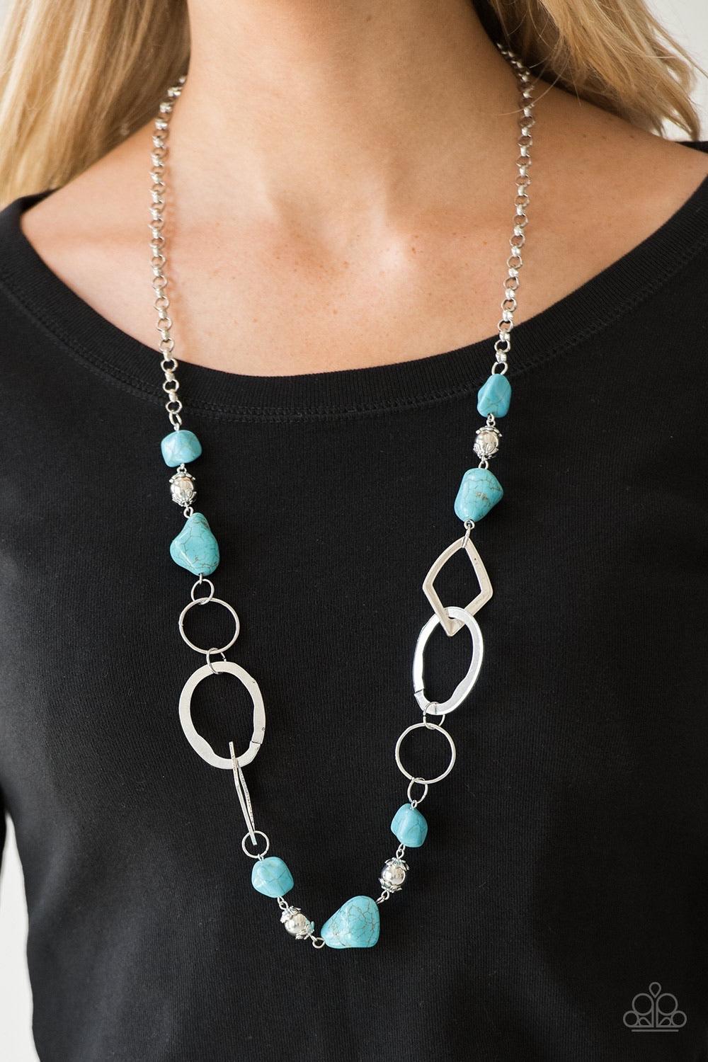 Paparazzi Accessories That’s TERRA-I fic! - Blue Bits of refreshing turquoise stones and ornate silver beading give way to asymmetrical silver frames. The mismatched frames drape across the chest, creating an earthy collision of rock and metal. Features a