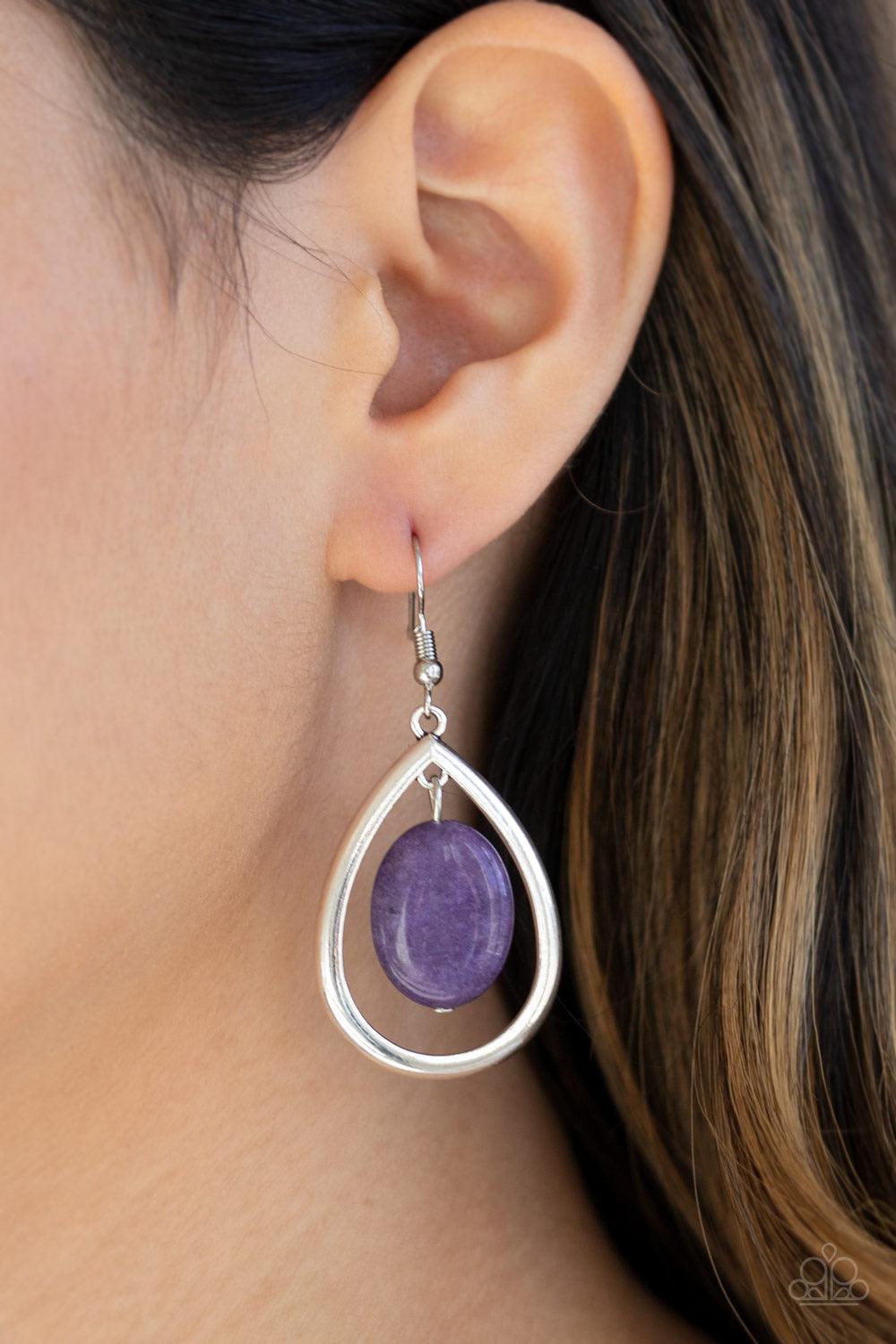 Paparazzi Accessories Seasonal Simplicity - Purple An oval purple stone swings from the bottom of an antiqued silver teardrop frame, creating a seasonal lure. Earring attaches to a standard fishhook fitting. As the stone elements in this piece are natural