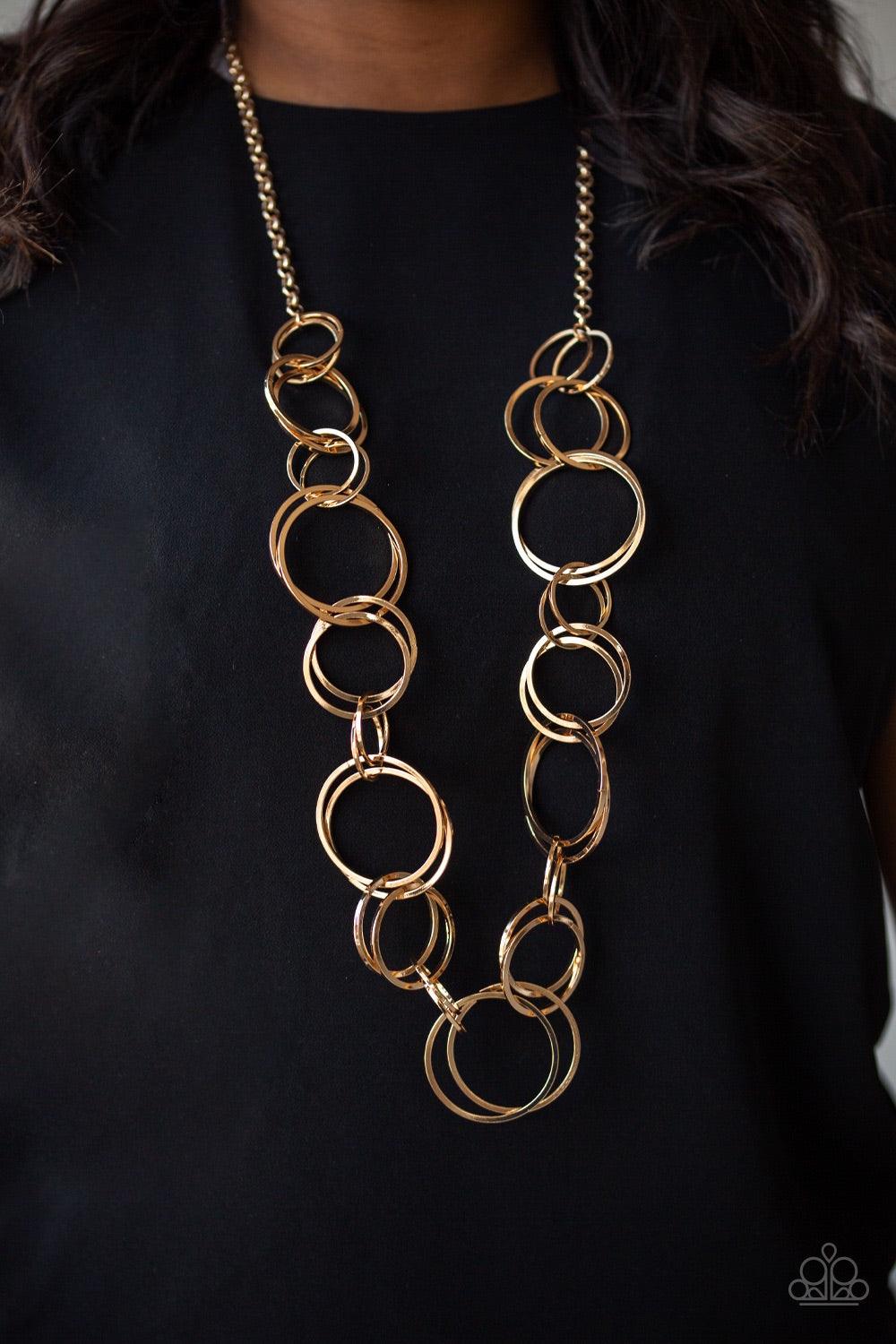 Paparazzi Accessories Natural Born RINGLEADER - Gold Pairs of dramatically oversized gold hoops connect across the chest, creating an elegantly elongated statement piece for a fearless look. Features an adjustable clasp closure. Jewelry