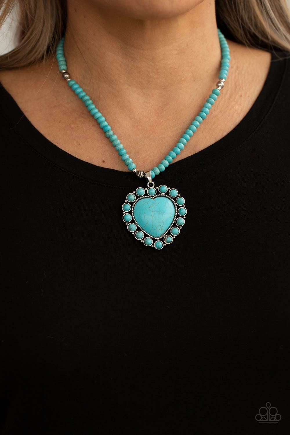 Paparazzi Accessories A Heart of Stone - Blue Bordered by dainty turquoise stones, an oversized turquoise stone heart pendant swings from the bottom of a turquoise stone and silver beaded display below the collar for a flirtatiously earthy fashion. Featur