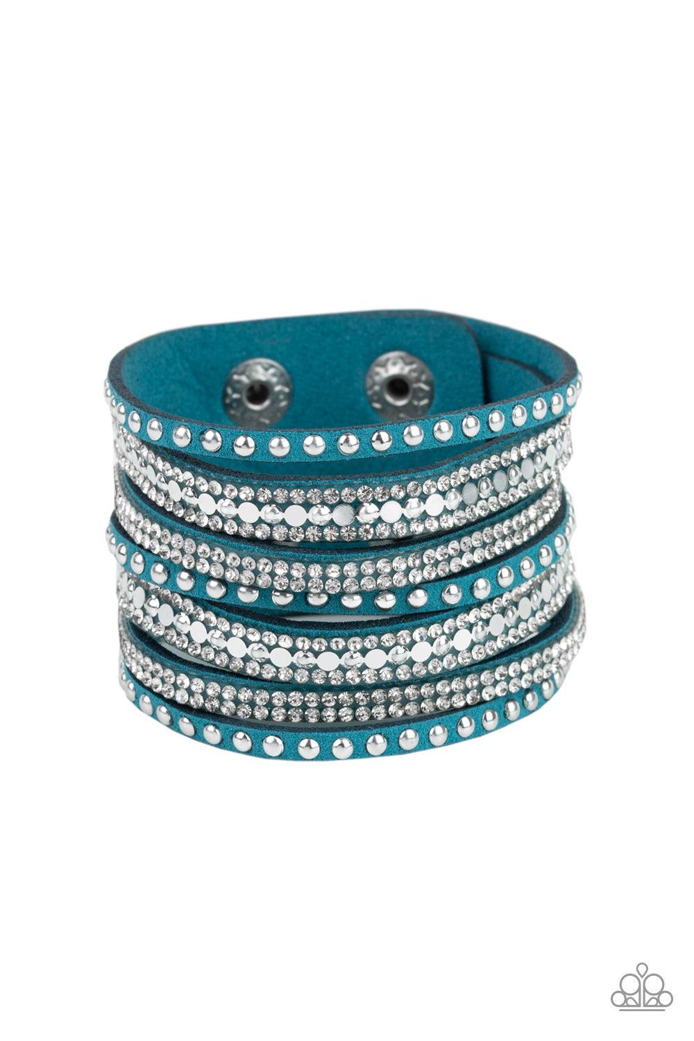 Paparazzi Accessories All Hustle and Hairspray - Blue A thick blue suede band has been spliced into glittery strands encrusted in a collection of dainty silver studs, glittery white rhinestones, and flat silver discs for a sassy look. Features an adjustab