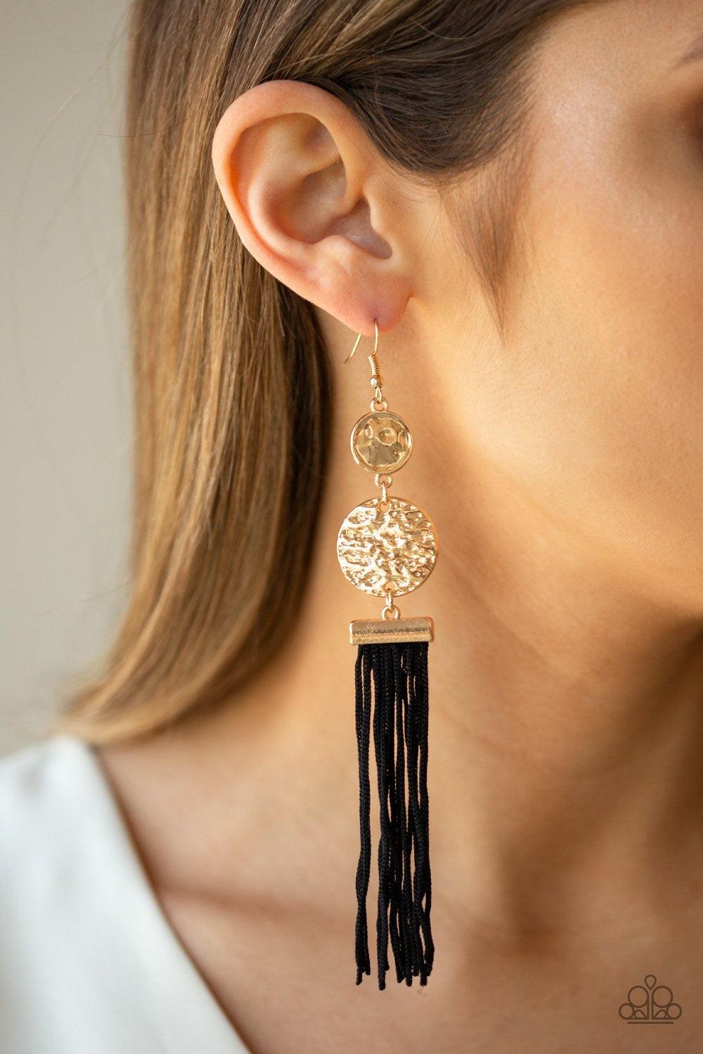 Paparazzi Accessories Lotus Gardens - Black A collection of black cording streams from the bottom of stacked hammered gold discs, creating a whimsical tassel. Earring attaches to a standard fishhook fitting. Jewelry