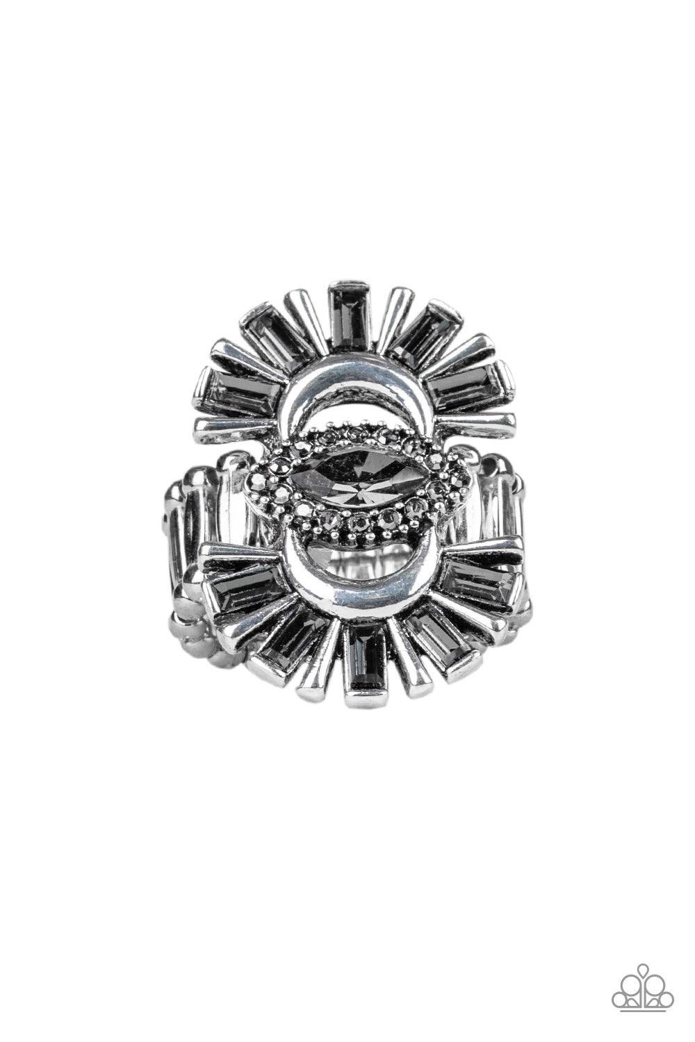 Paparazzi Accessories Deco Diva - Silver A collision of smoky emerald-cut rhinestones and antiqued silver frames flare from the top and bottom of a smoky rhinestone encrusted center, creating a dramatic centerpiece atop the finger. Features a stretchy ban