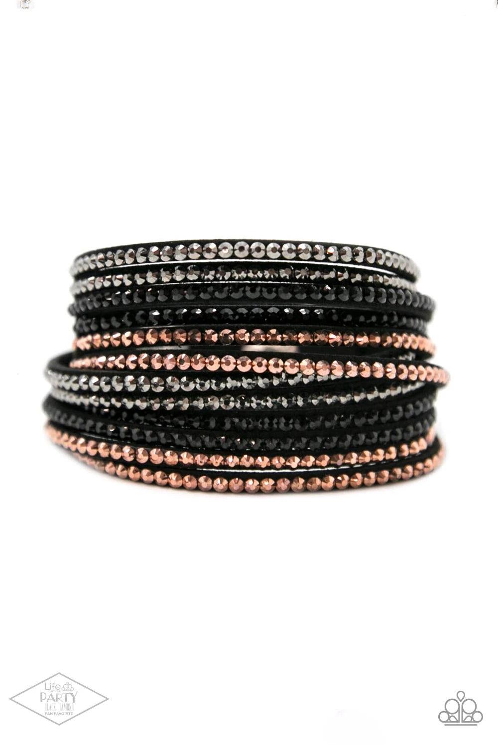 Paparazzi Accessories Do The Hustle - Black Black suede is spliced into six strands and embellished with rows of black, hematite, and metallic rhinestones brushed in a copper finish for a glitzy combination. The elongated leather band allow for a trendy d