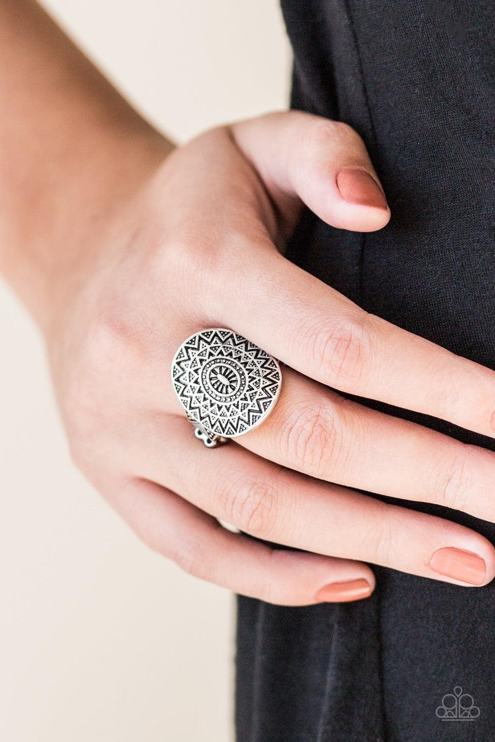 Paparazzi Accessories Good For The SOL - Silver Brushed in an antiqued shimmer, a glistening silver frame radiates with a sunburst pattern for a tribal inspired look. Features a dainty stretchy band for a flexible fit. Jewelry
