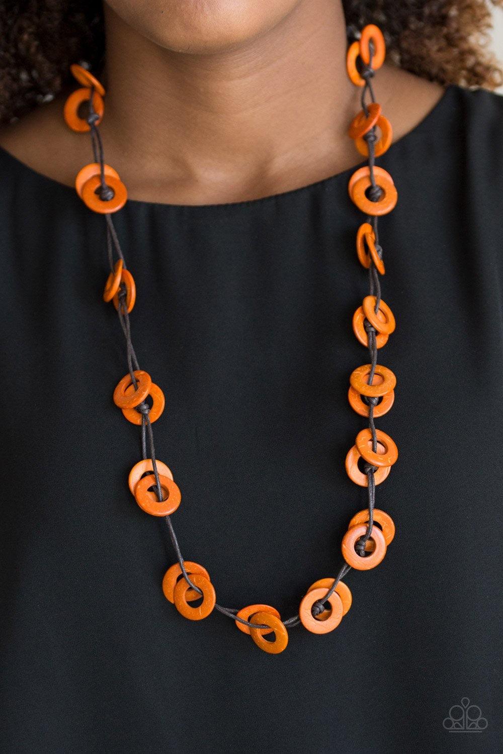Paparazzi Accessories Waikiki Winds - Orange Shiny brown cording knots around vivacious orange wooden discs, creating a colorful display across the chest. Features a button loop closure.Sold as one individual necklace. Includes one pair of matching earrin