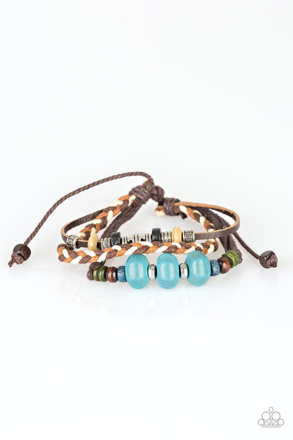 Paparazzi Accessories Catch Me CLIFF You Can - Blue Refreshing turquoise stones, colorful wooden beads, and metallic accents are knotted along mismatched leather and corded bands for a seasonal look. Features an adjustable sliding knot closure. Jewelry