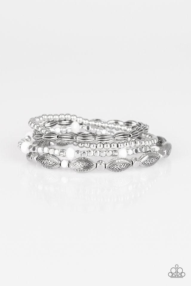 Paparazzi Accessories Full of Wander - White Infused with faceted white beads, a collection of mismatched silver beads are threaded along stretchy bands, creating colorful layers across the wrist. Jewelry