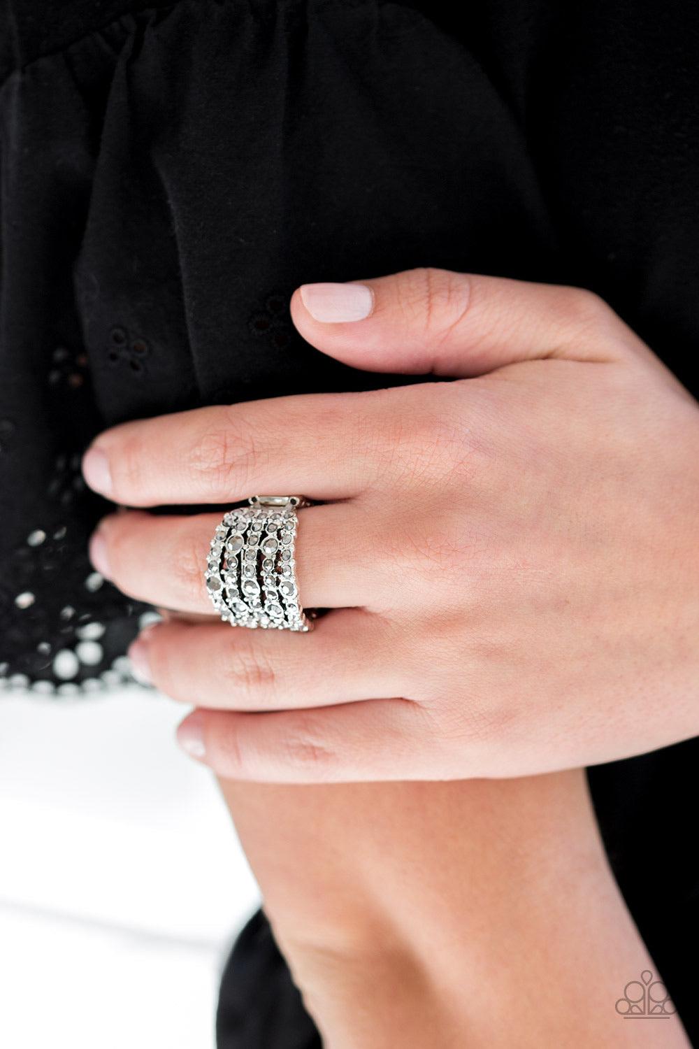 Paparazzi Accessories Truly Treasured - Silver Varying in size, row after row of glittery hematite rhinestones are encrusted along studded silver bands for a dazzling look. Features a stretchy band for a flexible fit. Jewelry