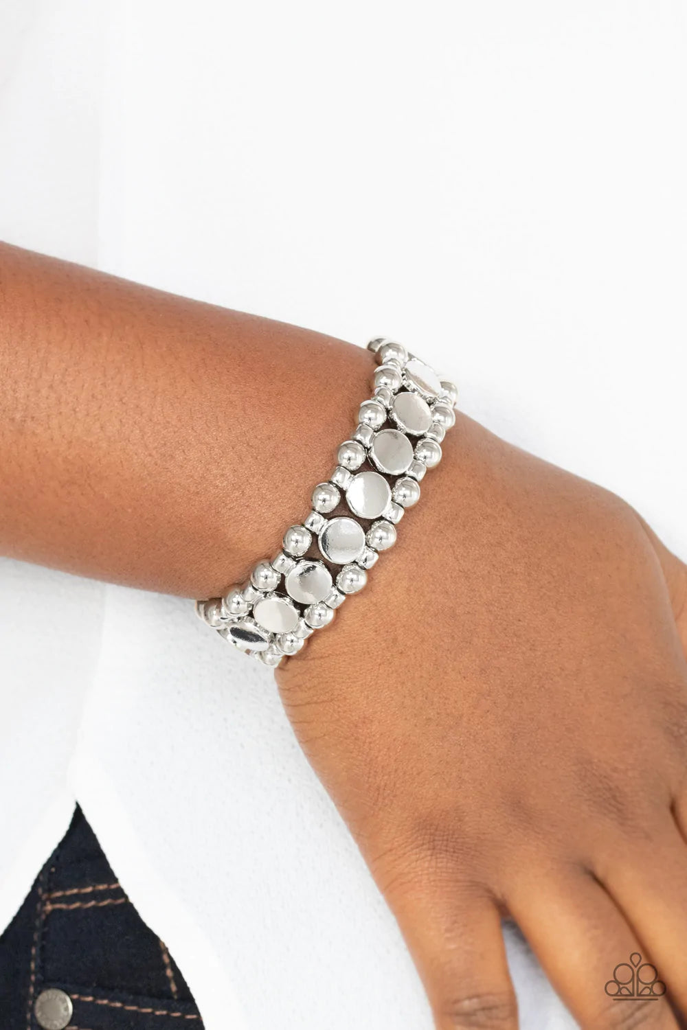 Paparazzi Accessories Metro Magnetism - Silver Shiny silver disc fittings and pairs of classic silver beads are threaded along stretchy bands around the wrist that connect into a bold industrial display around the wrist. Sold as one individual bracelet. B