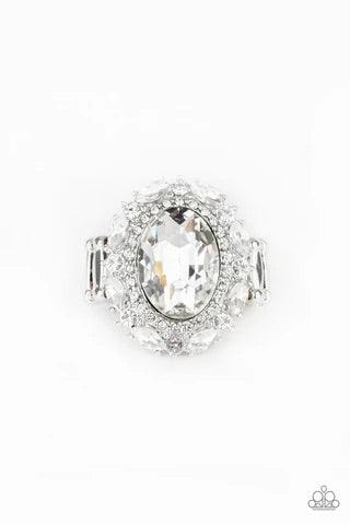 Paparazzi Accessories Show Glam - White An oversized oval white gem is pressed into the center of a round silver frame encrusted in mismatched white rhinestones for a glamorous look. Features a stretchy band for a flexible fit. Sold as one individual ring