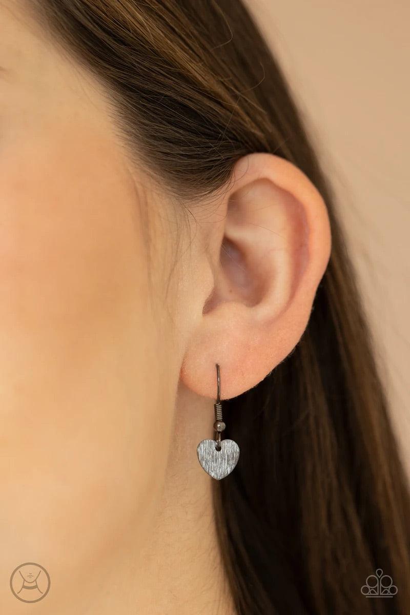 Paparazzi Accessories Playing HEART To Get - Black Featuring a shimmery scratch finish, a dainty collection of shiny gunmetal heart frames connect around the neck for a flirtatious look. Feature an adjustable clasp closure. Sold as one individual choker n
