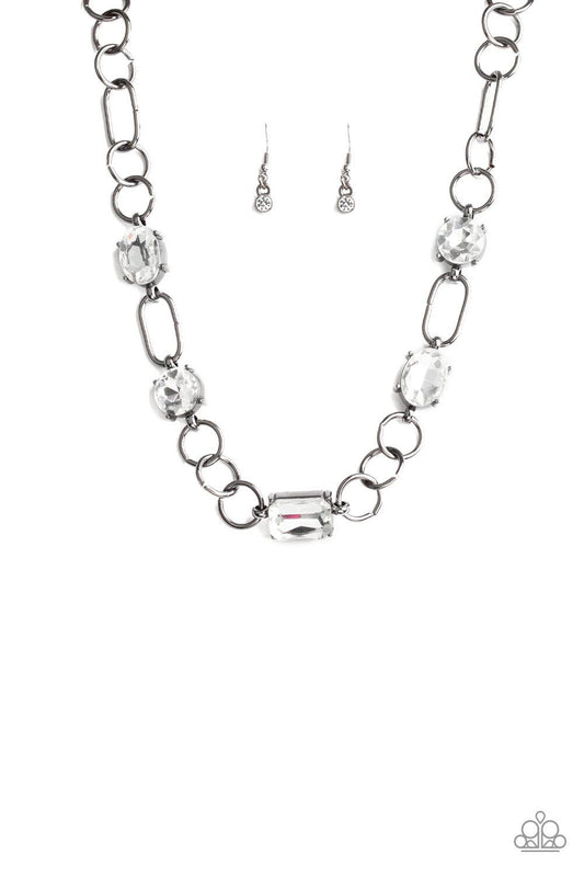 Paparazzi Accessories Urban District - Black Featuring round, oval, and emerald style cuts, glittery white rhinestone fittings link with mismatched gunmetal rings below the collar for an edgy glamorous look. Features an adjustable clasp closure. Necklaces