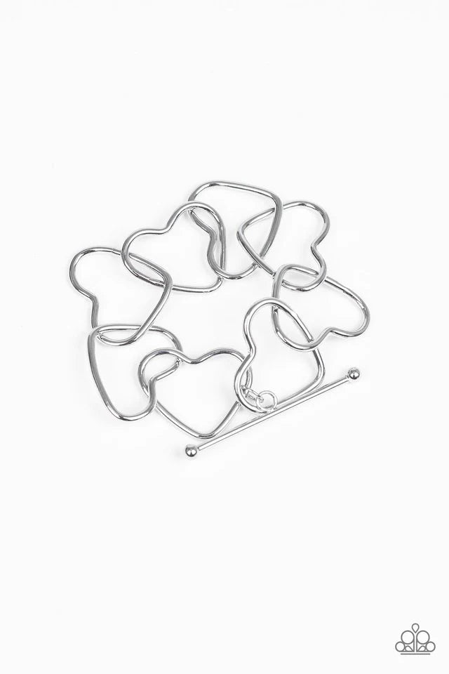 Paparazzi Accessories Take Heart - Silver Airy silver heart silhouettes connect around the wrist for a flirtatious look. Features a toggle closure. Sold as one individual bracelet. Jewelry