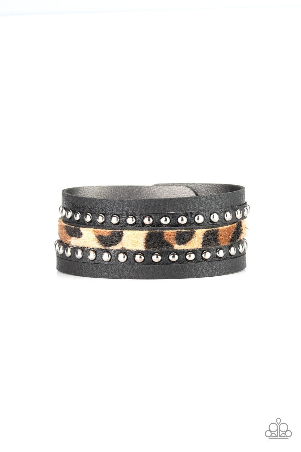 Paparazzi Accessories Born to be WILDCAT - Brown A thick band of black leather has been spliced into layered bands that have been studded and printed in a fuzzy cheetah print for a wild look. Features an adjustable snap closure. Jewelry