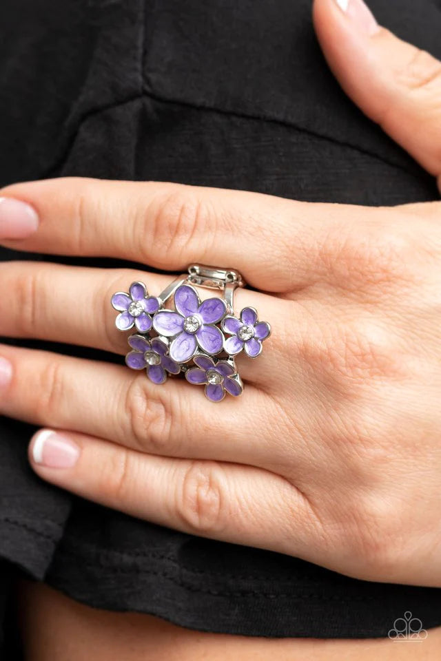Paparazzi Accessories Boastful Blossoms - Purple Dotted with dainty white rhinestone centers, a bouquet of shiny purple flowers blooms across the finger for a sensational seasonal look. Features a stretchy band for a flexible fit. Sold as one individual r