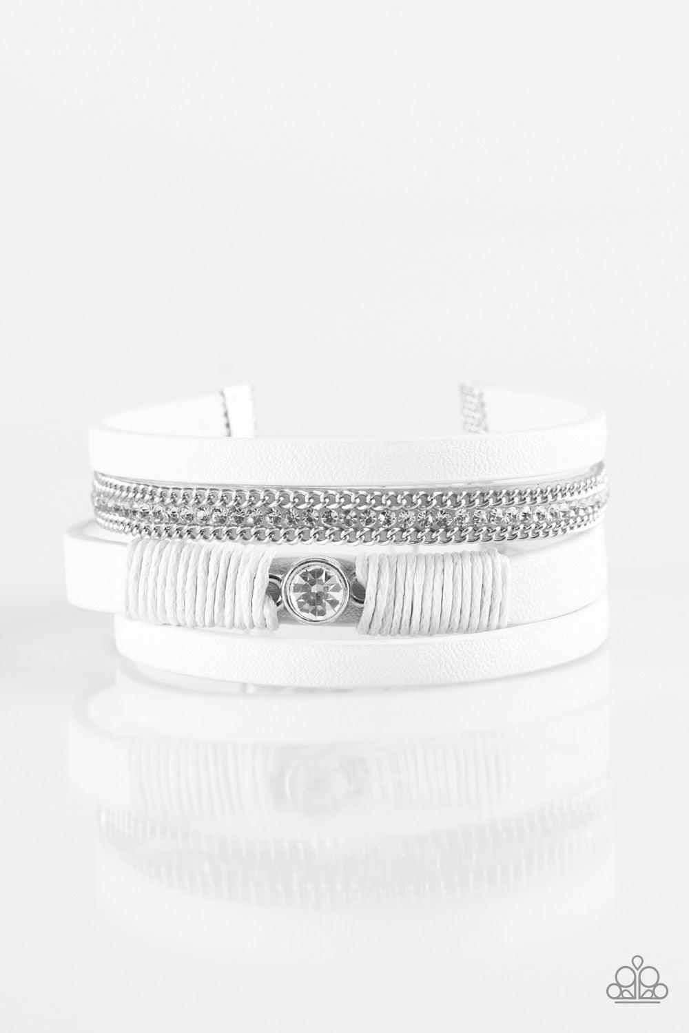 Paparazzi Accessories Catwalk Craze - White White leather strands layer across the wrist. Infused with silver chain and white rhinestone accents, white cording knots around a leather strand, securing a solitaire white rhinestone in place for a whimsical f