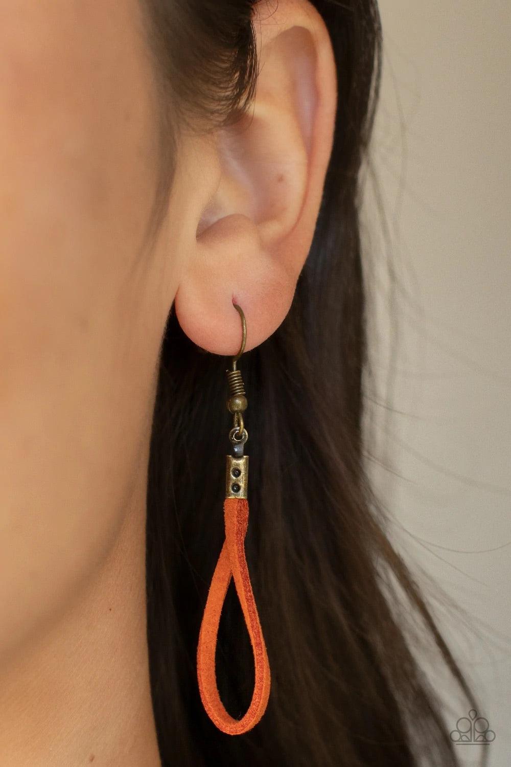 Paparazzi Accessories Noticeably Nomad - Orange Flanked by dainty brass rings, a marquise shaped brass bead glides along lengthened strands of rustic orange suede, holding in place an oversized brass ring at the bottom for an artisan inspired fashion. Fea