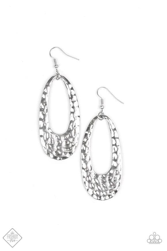 Paparazzi Accessories Artisan Abundance - Silver Delicately hammered in endless ripples of shimmer, an elongated oval silver hoop swings from the ear for an authentic artisan inspired look. Earring attaches to a standard fishhook fitting. Sold as one pair