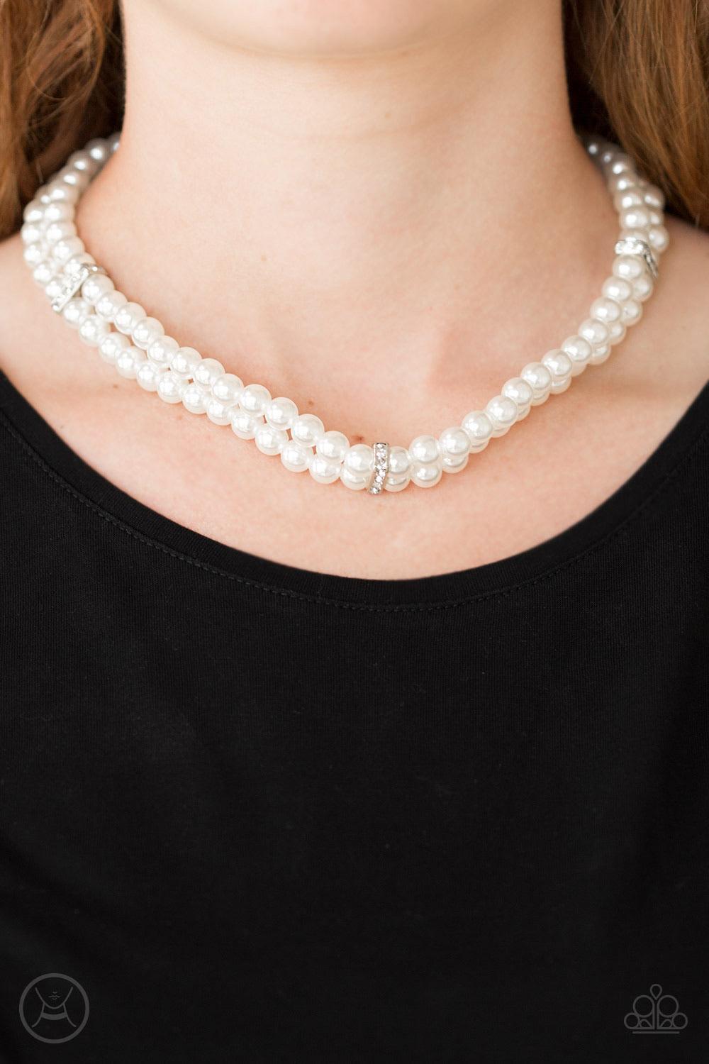 Paparazzi Accessories Put On Your Party Dress - White Pinched between white rhinestone encrusted frames, strands of classic white pearls layer around the neck for a timeless look. Features an adjustable clasp closure. Sold as one individual choker necklac