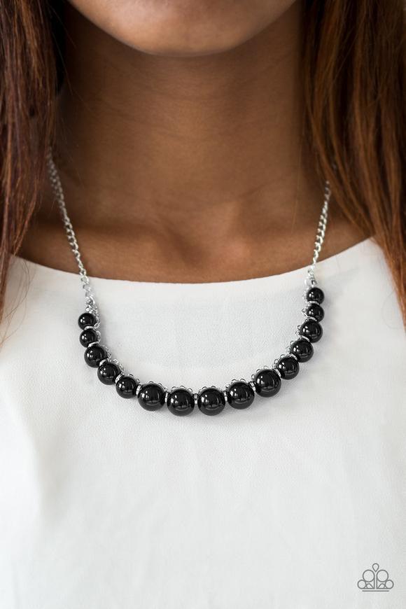 Paparazzi Accessories The FASHION Show Must Go On! - Black A classic strand of shiny black beads is threaded along an invisible string, creating a stationary pendant below the collar. Infused with shimmery silver accents, silver chain weaves atop the bead