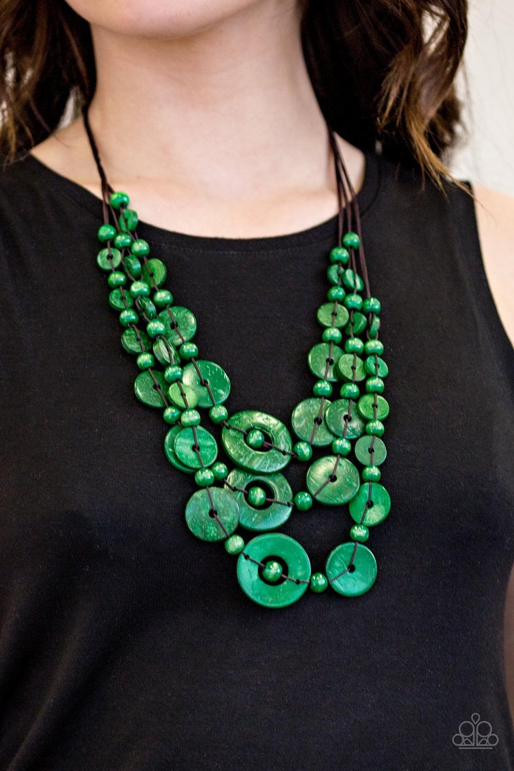 Paparazzi Accessories Bali Boardwalk - Green Brushed in a distressed finish, refreshing green wooden beads and discs trickle along three strands, creating a summery look down the chest. Features a button loop closure. Necklaces