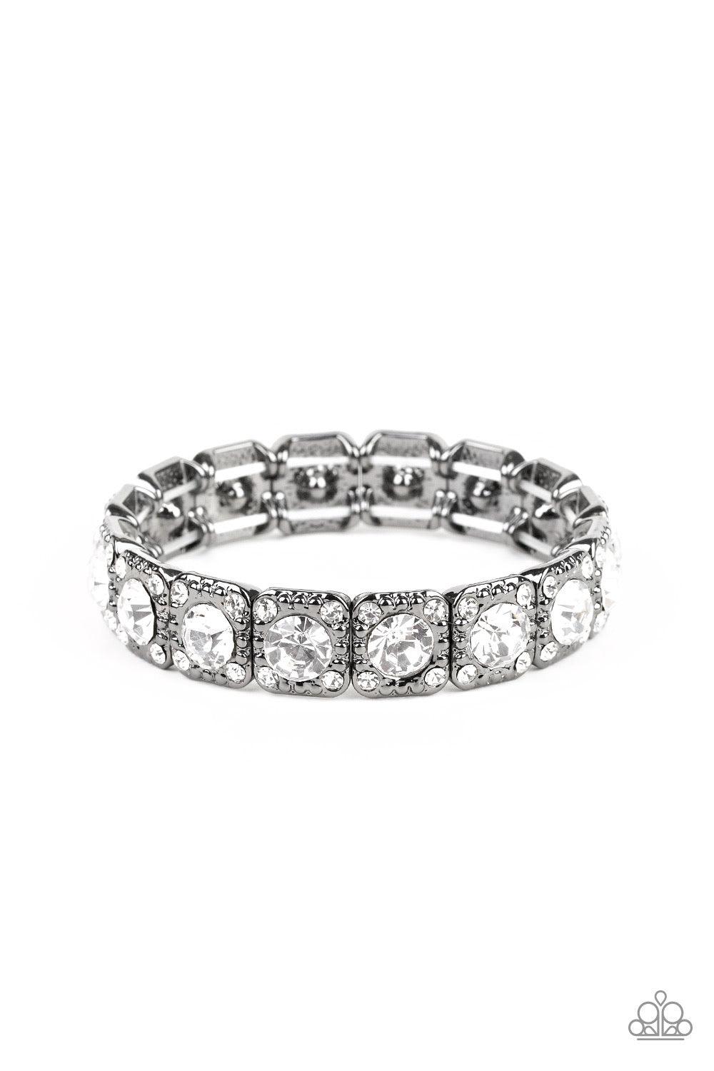 Paparazzi Accessories Blinged Out - Black Featuring oversized white rhinestone centers, studded gunmetal frames radiating in glassy white rhinestones are threaded along a stretchy band around the wrist for a glamorous fashion. Jewelry