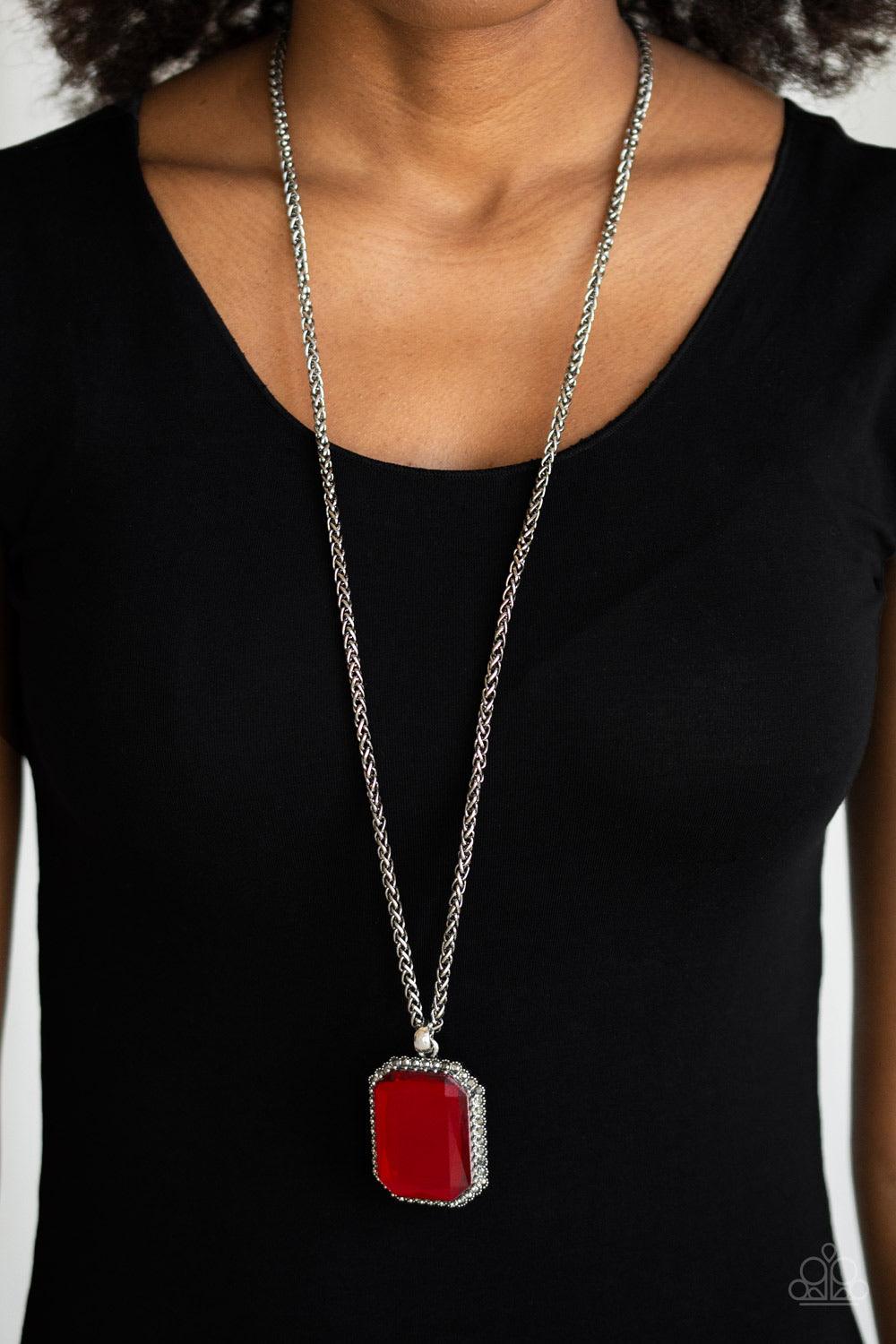 Paparazzi Accessories Let Your HEIR Down ~Red Bordered in dainty hematite rhinestones, an oversized faceted red emerald style gem swings from the bottom of an antiqued silver wheat chain for a blinding look. Features an adjustable clasp closure.