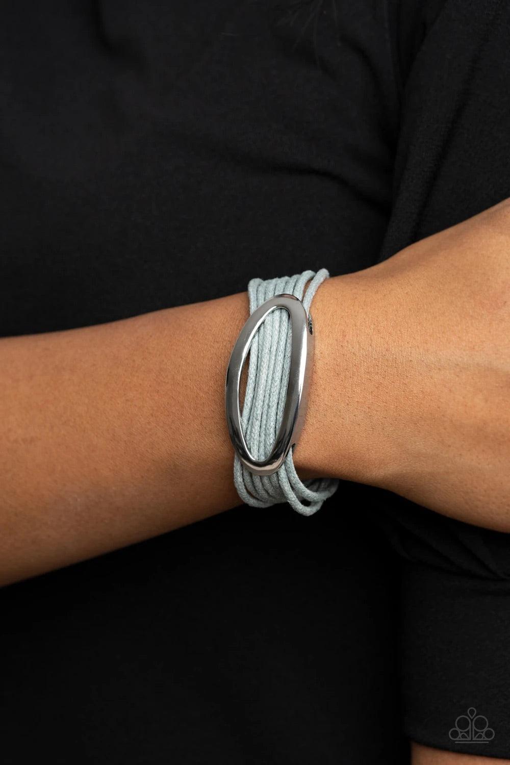 Paparazzi Accessories Corded Couture - Silver An oval silver fitting glides along strands of gray cording, creating colorful layers around the wrist. Features a magnetic closure. Sold as one individual bracelet. Jewelry
