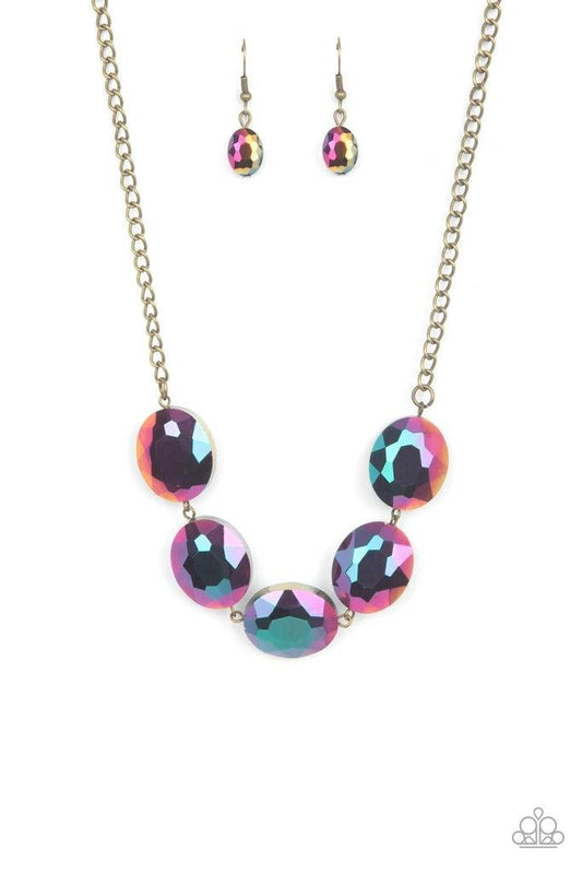 Paparazzi Accessories Cosmic Closeup - Brass Dipped in a metallic oil spill finish, a faceted collection of oversized iridescent gems delicately links below the collar for a gritty glamorous look. Features an adjustable clasp closure. Sold as one individu