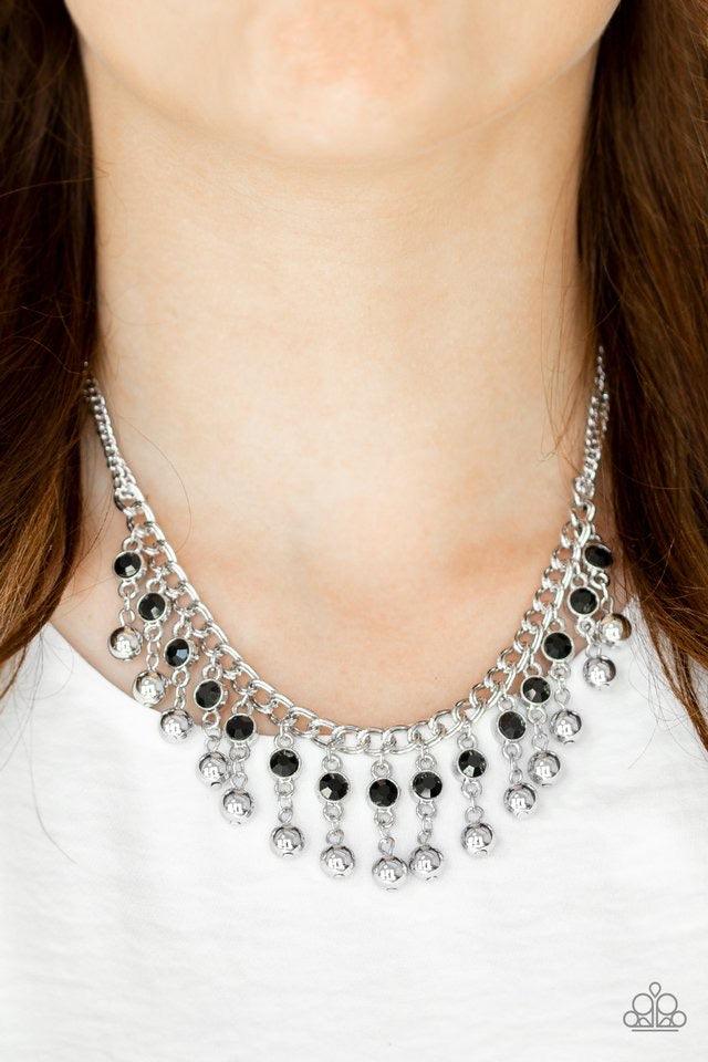 Paparazzi Accessories Pageant Queen - Black Sparkling black rhinestones drip from the bottom of a bold silver chain. Classic silver beads swing from the bottoms of the glittery rhinestones, creating a glamorous fringe below the collar. Features an adjusta