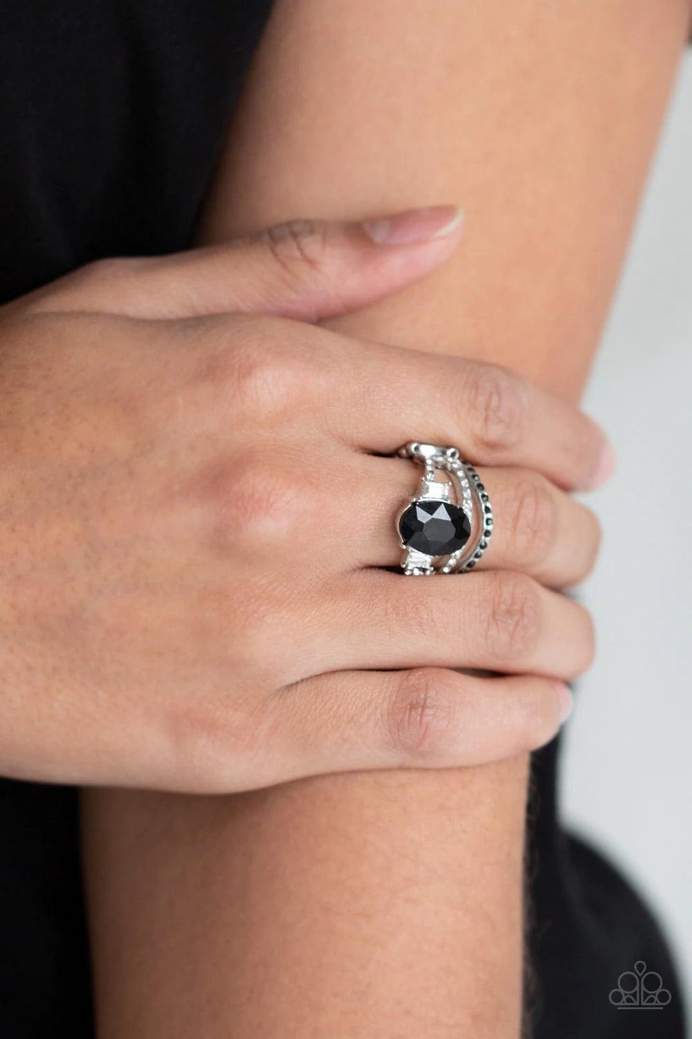 Paparazzi Accessories Spectacular Sparkle - Black Paparazzi Accessories $5 Jewelry. Encrusted with glittery black and glassy white rhinestones, three shimmery silver bands arc across the finger. The uppermost band is crowned with a dramatic black rhinesto