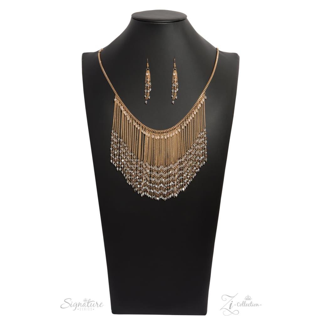 Paparazzi Accessories The DonnaLee Countless gold chains stream from the bottom of a glistening gold chain, creating a curtain of show-stopping fringe that falls just below the collar. Faceted crystal-like beading lays across the top of the cascading chai