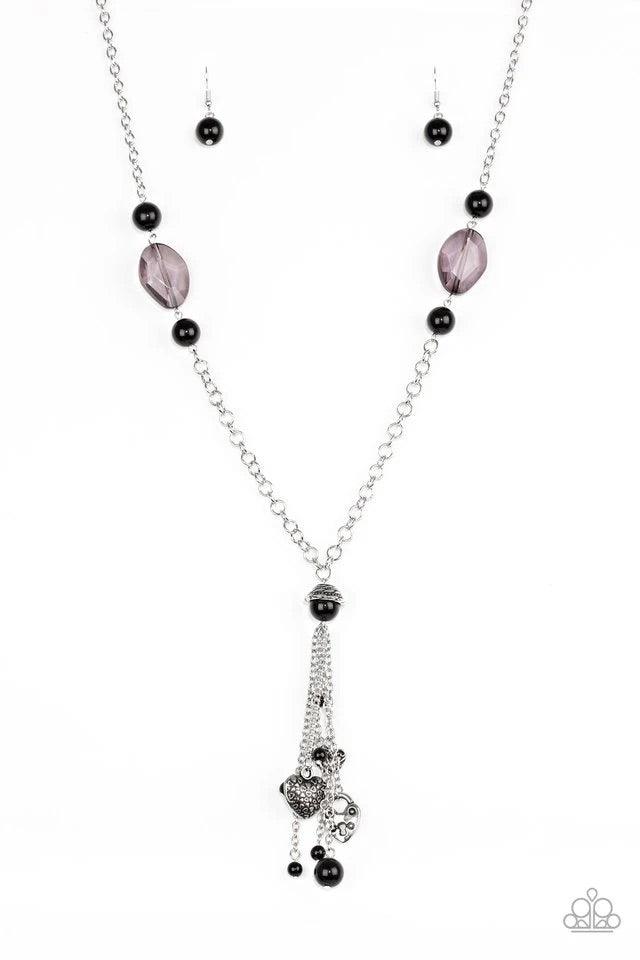 Paparazzi Accessories Heart-Stopping Harmony - Black Glassy and shiny black beading trickles down the sides of an elegantly elongated silver chain. A collection of silver heart charms and black beads swing from the bottom of the chain, creating a whimsica