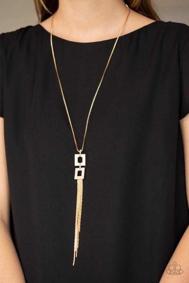 Paparazzi Accessories Time Square Stunner - Gold Encrusted in glittery white rhinestones, two gold square frames link at the bottom of a lengthened gold box chain. Flattened gold chains stream from the bottom of the stacked pendant, creating an edgy tasse