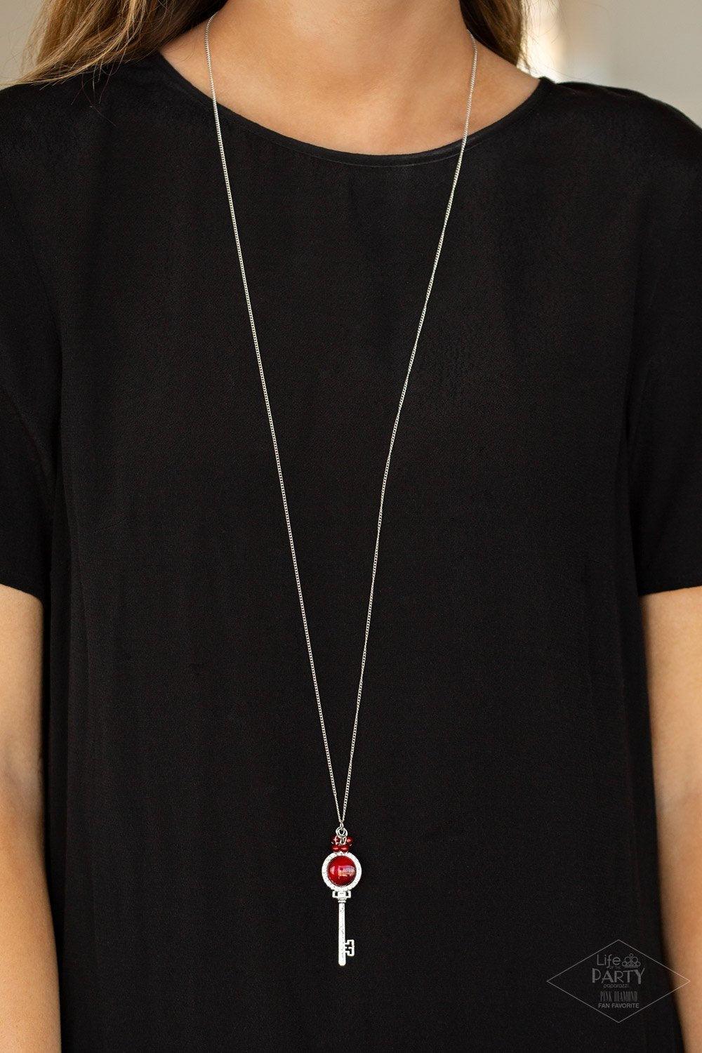 Paparazzi Accessories Unlock Every Door - Red A luminescent red cat's eye stone is pressed into a silver key charm, creating a colorful pendant. Infused with iridescent red cat's eye beading, the silver key is encrusted in glittery white rhinestones for a
