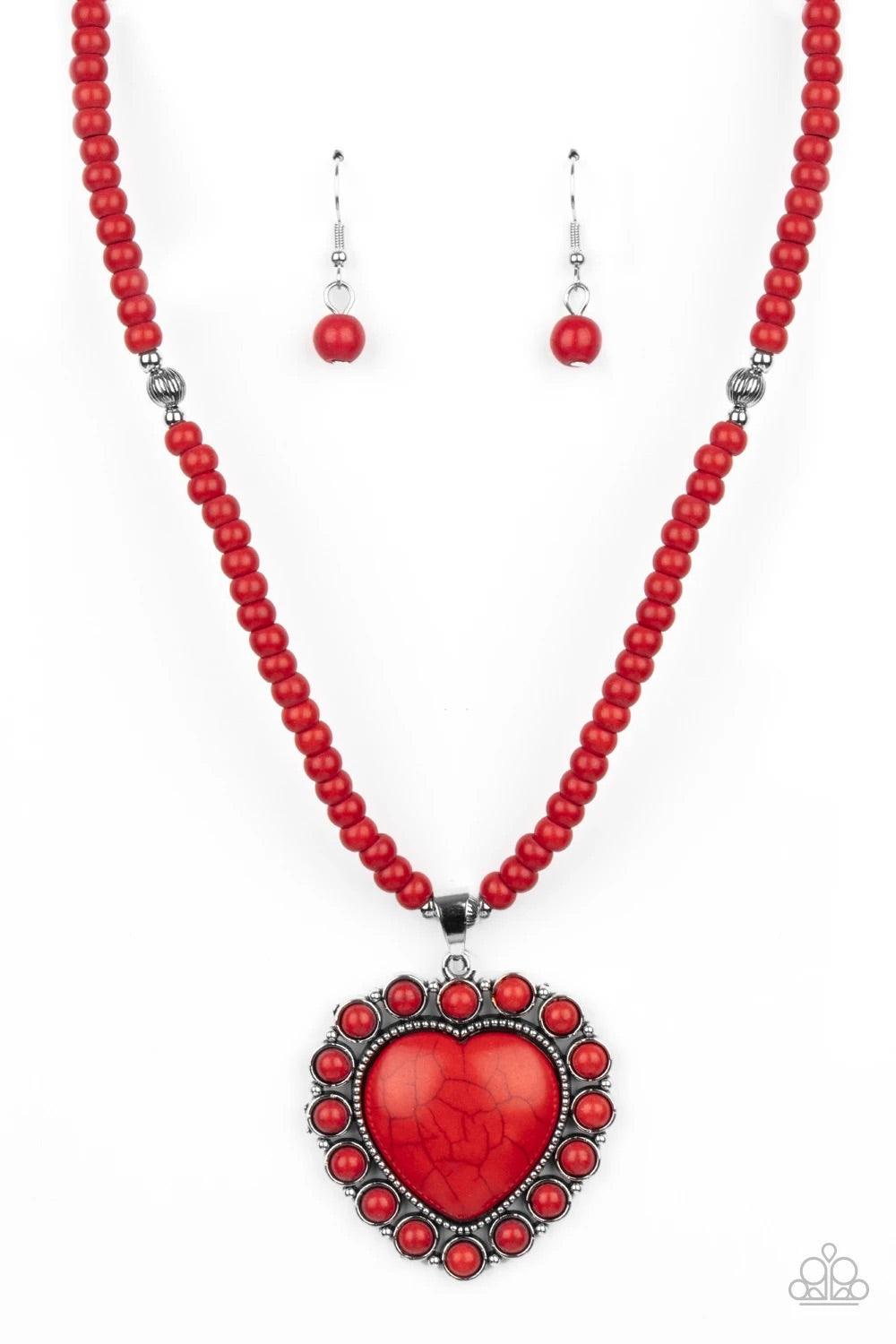 Paparazzi Accessories A Heart of Stone - Red Bordered by dainty red stones, an oversized red stone heart pendant swings from the bottom of a red stone and silver beaded display below the collar for a flirtatiously earthy fashion. Features an adjustable cl