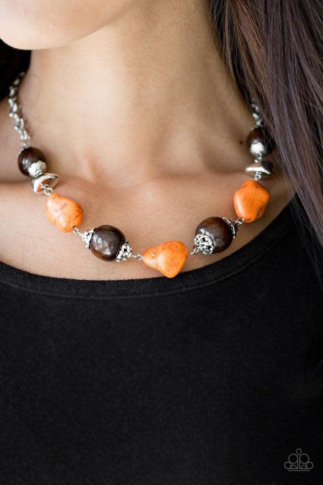 Paparazzi Accessories Earth Goddess - Orange Infused with ornate silver accents, orange stones and round wooden beads trickle along a shimmering silver chain, creating an artisanal statement piece that falls just below the collar. Features an adjustable c