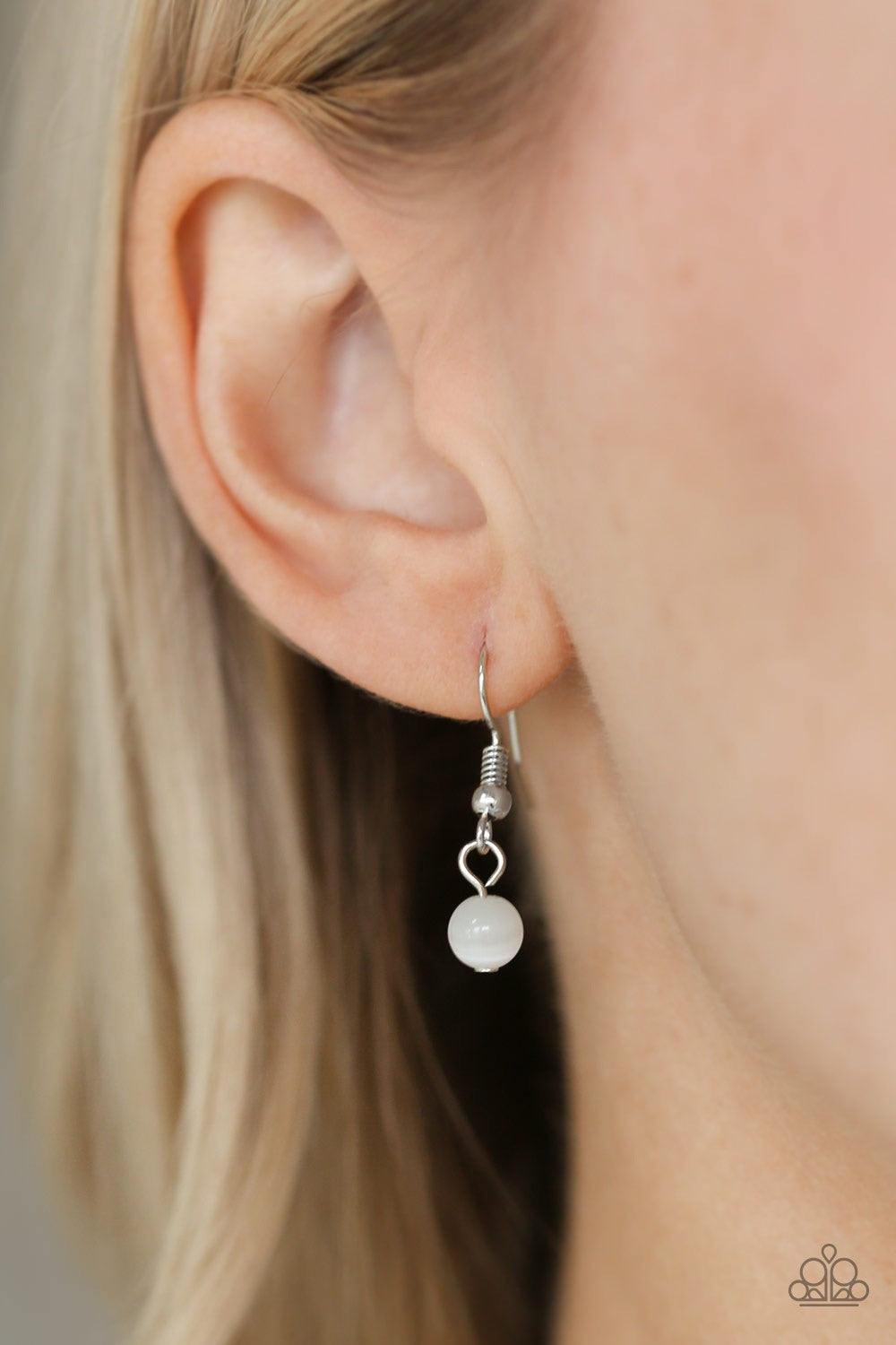 Paparazzi Accessories Mom Hustle - White Infused with white cat's eye accents, a dainty silver heart, rectangular frame stamped with "love", and a locket-like heart stamped with the word "mom", collect at the bottom of a silver chain for a vintage inspire