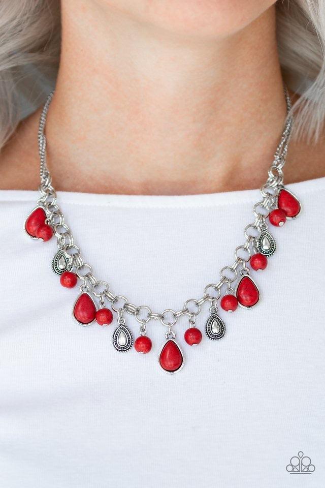 Paparazzi Accessories Welcome To Bedrock ~Red Chiseled into round and teardrop shapes, fiery red stones swing from the bottom of a bold double-linked silver chain below the collar. Embossed in studded details, shimmery silver teardrops drip between the st