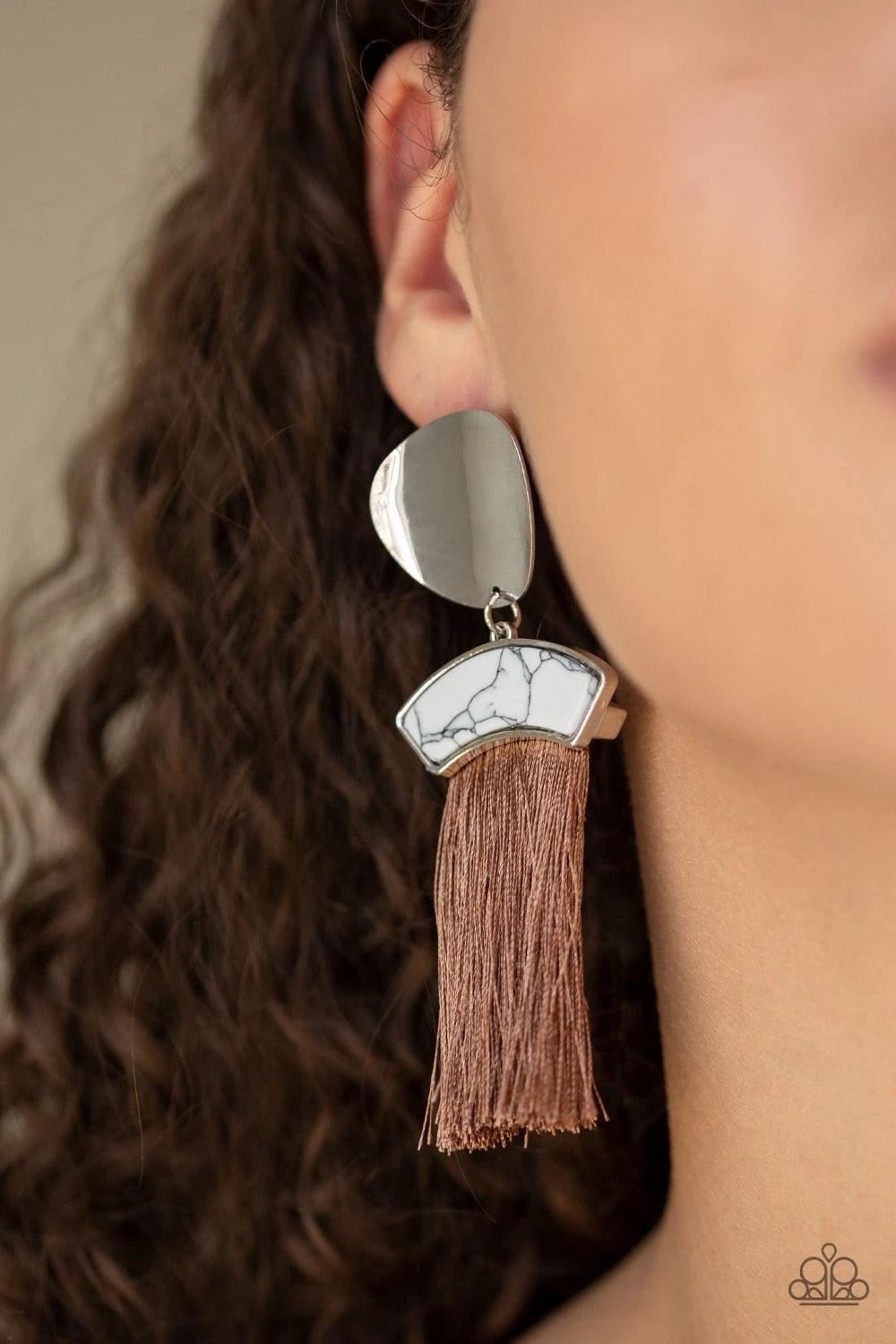 Paparazzi Accessories Insta Inca - Brown A plume of shiny brown thread streams from the bottom of a white stone frame that links with an asymmetrical silver disc, creating flirtatious tassel. Earring attaches to a standard post fitting. Sold as one pair o