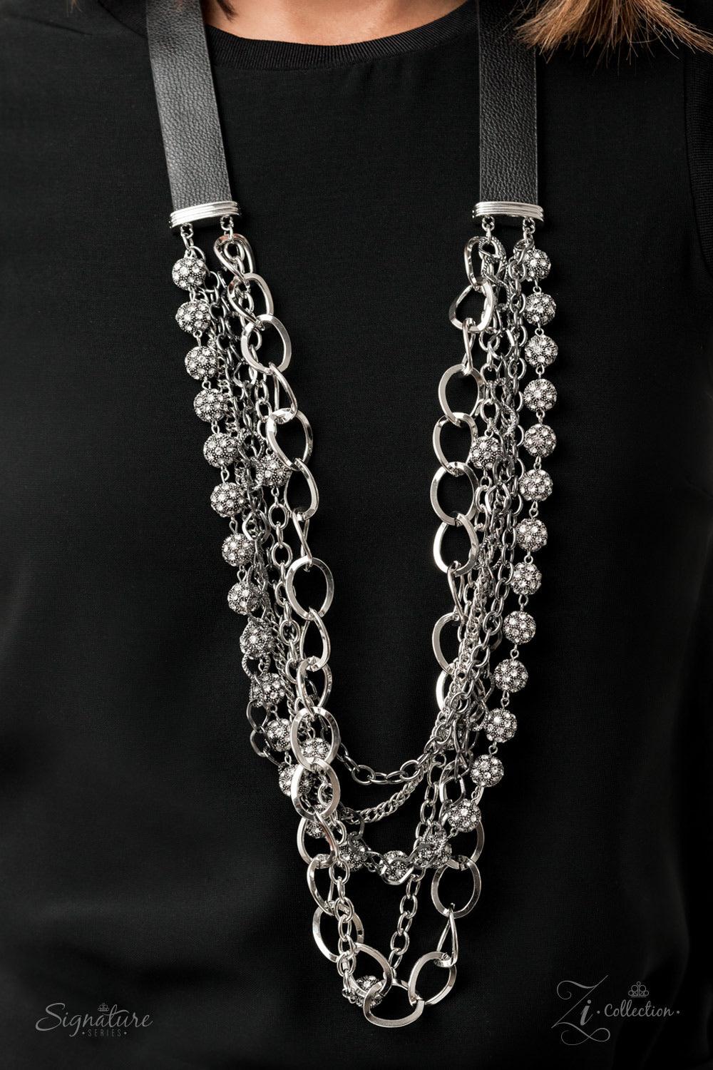 Paparazzi Accessories The Arlington 💗💗ZiCollection $25💗💗 Attached to two strips of black leather, strands of bedazzled white rhinestone encrusted silver beads drape between an exaggerated display of mismatched silver and gunmetal chains down the chest