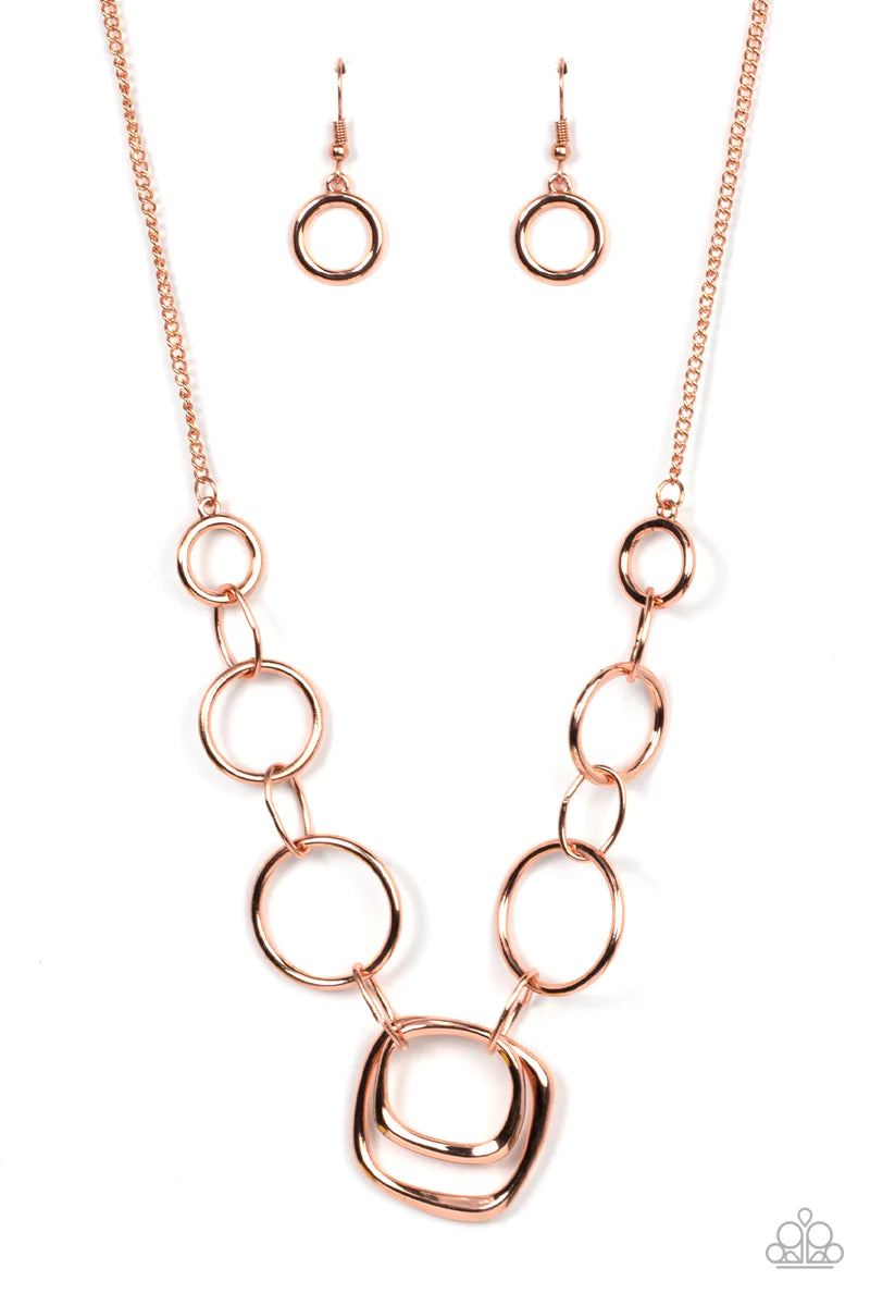 Paparazzi Accessories Linked Up Luminosity - Copper A mismatched collection of shiny copper rings and asymmetrical shiny copper hoops delicately links below the collar, resulting in a modern industrial display. Features an adjustable clasp closure. Neckla