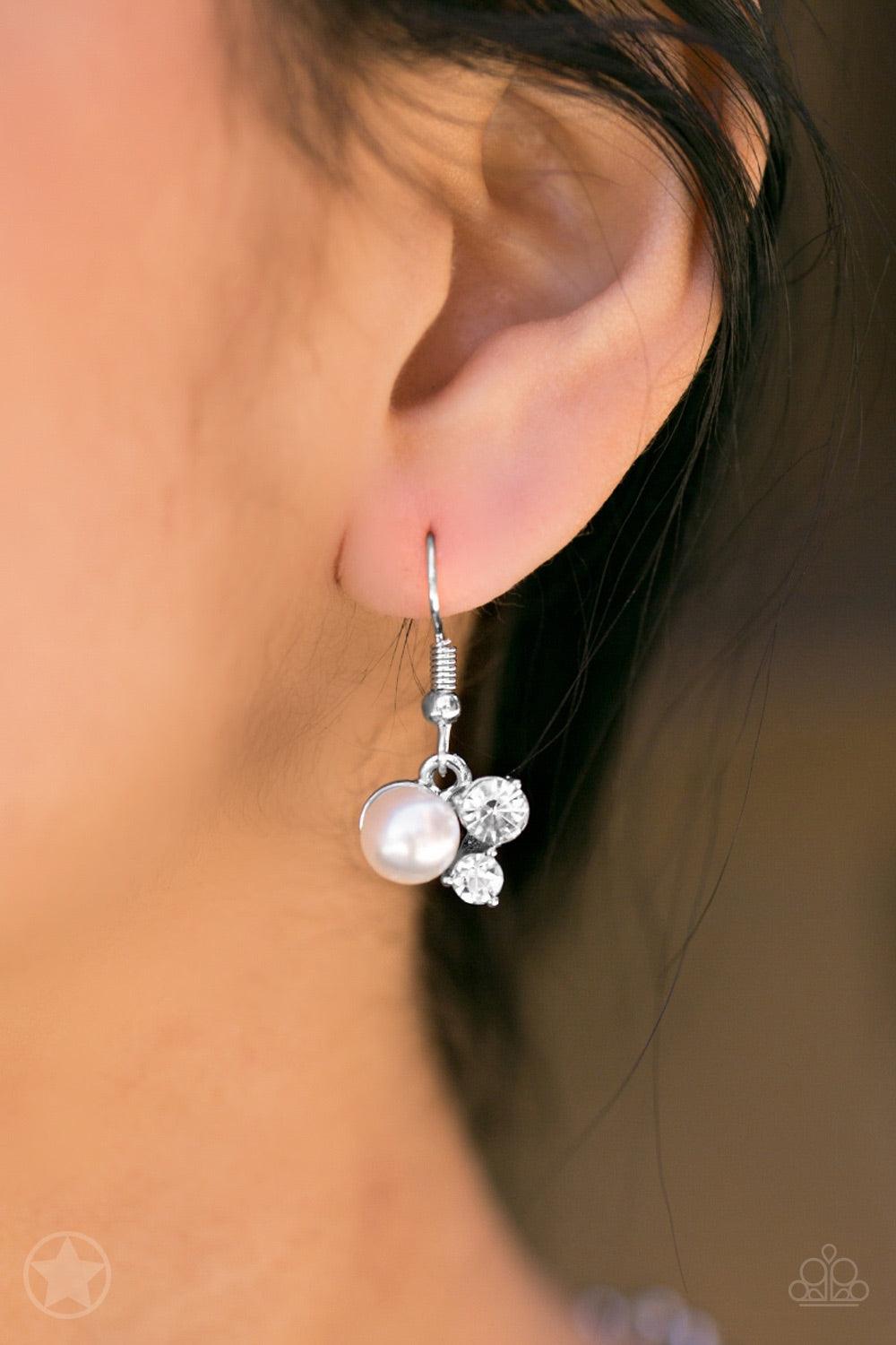Paparazzi Accessories Toast To Perfection - White Clusters of pearls and dazzling white rhinestones join below the collar, creating refined frames. Infused with a glistening silver chain, the sections of luminescent frames trickle along the neck in a time